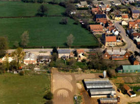 Aerial view of Castle Hill Road, pig farm and old village hall